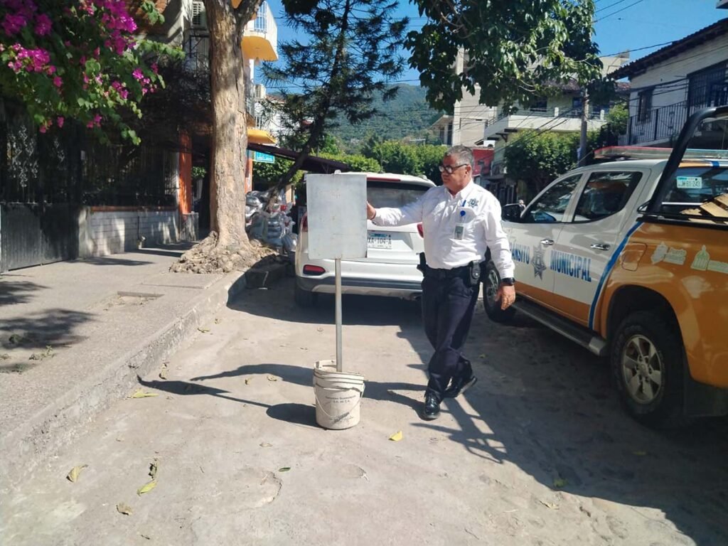 a man standing next to a sign